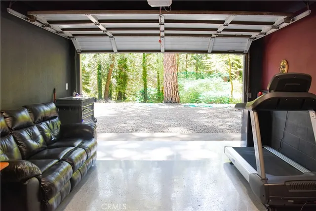 a room with furniture and a gym machine