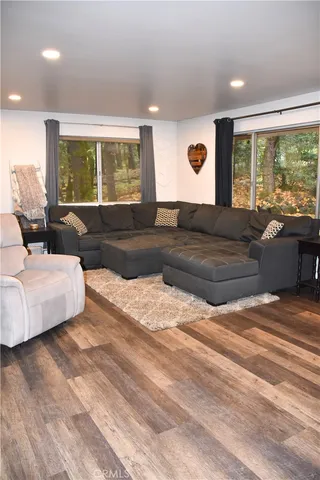 a living room with furniture window and wooden floor
