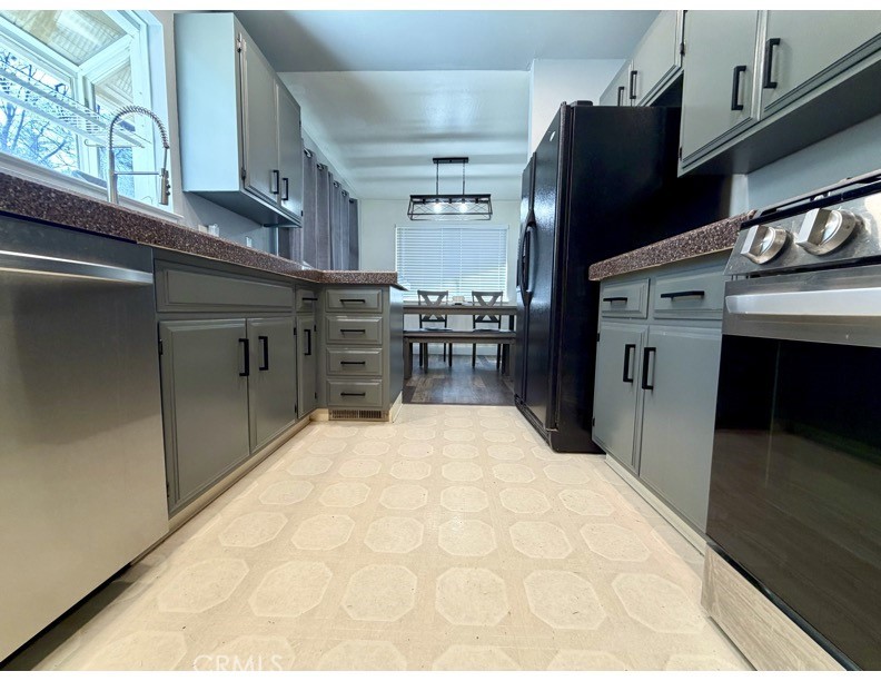 4728 Hartley Drive Forest Ranch, CA 95942 - Photo 8 of 33 a kitchen with stainless steel appliances kitchen island granite countertop a refrigerator stove and sink