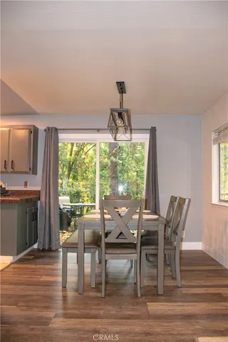 a dining room with furniture window and wooden floor