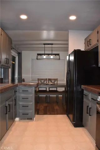 a kitchen with cabinets and stainless steel appliances