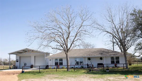 a view of a large building with a big yard and large trees