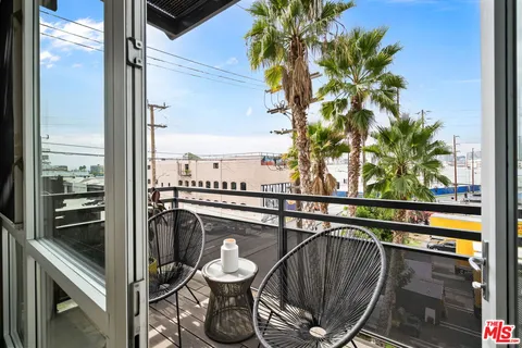 a view of a balcony with chairs