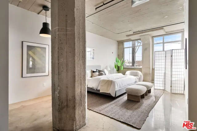 a bedroom with bed and a couch