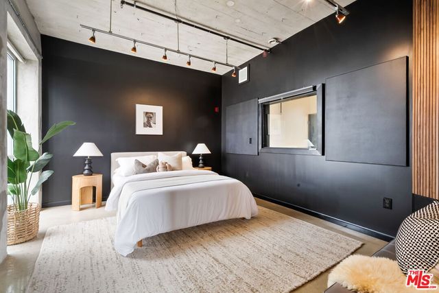 a bedroom with a bed and a couch