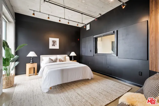 a bedroom with a bed and a couch