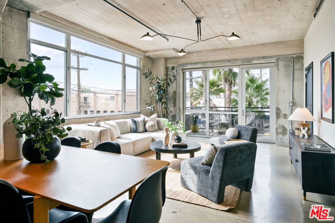 825 East 4th Street, Unit 310 Los Angeles, CA 90013 - Photo 8 of 33 a living room with furniture potted plant and a large window