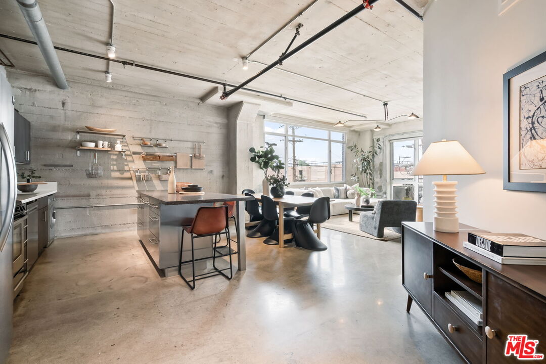 825 East 4th Street, Unit 310 Los Angeles, CA 90013 - Photo 9 of 33 a living room with lots of furniture and a flat screen tv