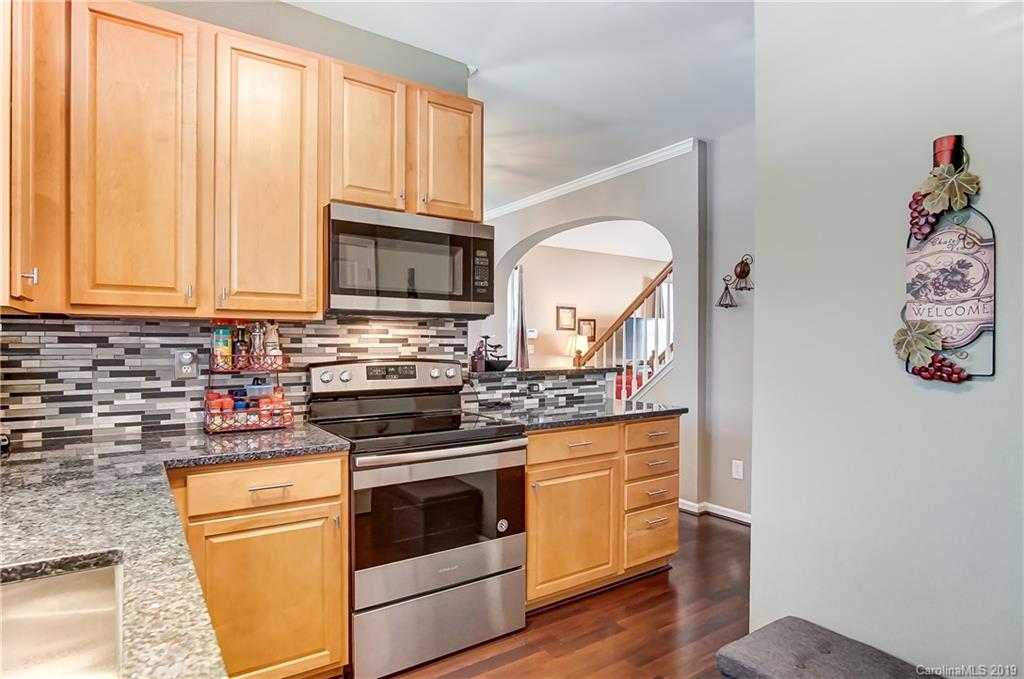 818 Gentlewinds Court Fort Mill, SC 29708 - Photo 11 of 22 a kitchen with stainless steel appliances granite countertop a stove and a microwave