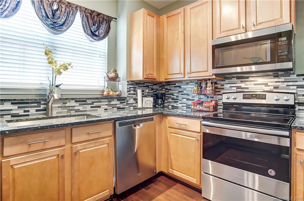 818 Gentlewinds Court Fort Mill, SC 29708 - Photo 12 of 22 a kitchen with stainless steel appliances granite countertop a stove and a microwave