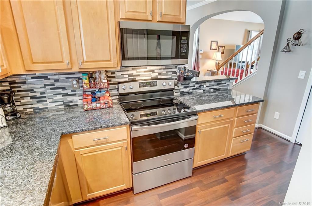 818 Gentlewinds Court Fort Mill, SC 29708 - Photo 13 of 22 a kitchen with stainless steel appliances granite countertop a stove and a sink