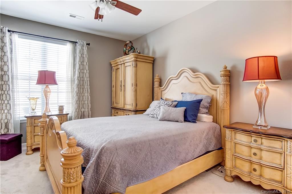 818 Gentlewinds Court Fort Mill, SC 29708 - Photo 15 of 22 a bedroom with a bed and wooden floor
