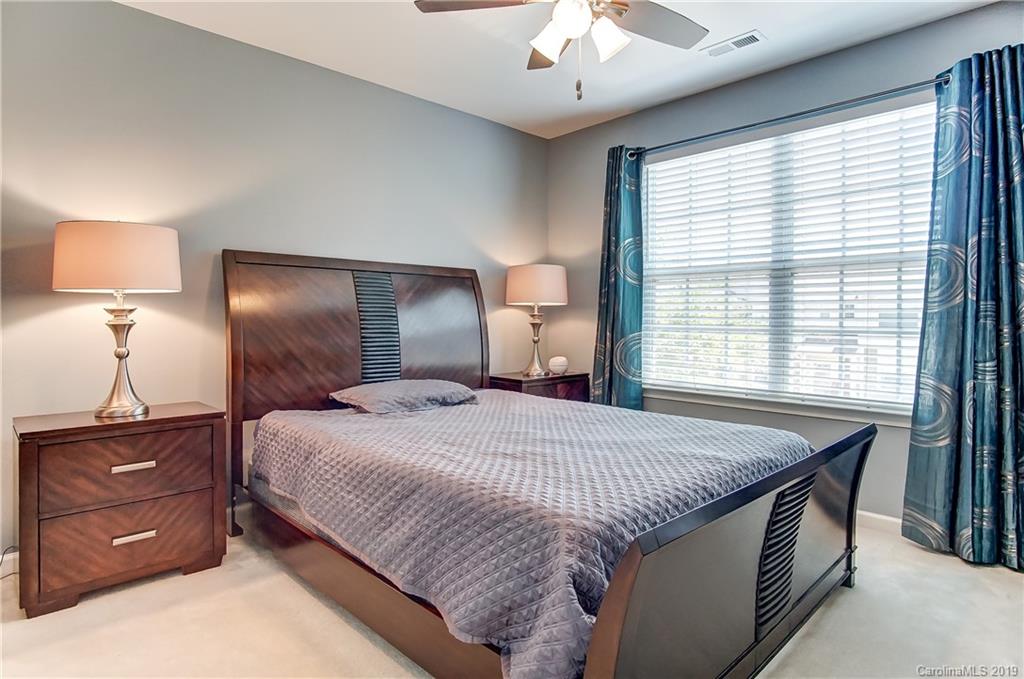 818 Gentlewinds Court Fort Mill, SC 29708 - Photo 17 of 22 a bedroom with a bed and a lamp