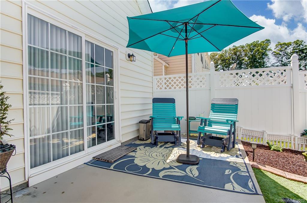 818 Gentlewinds Court Fort Mill, SC 29708 - Photo 20 of 22 a view of a patio with couches under an umbrella