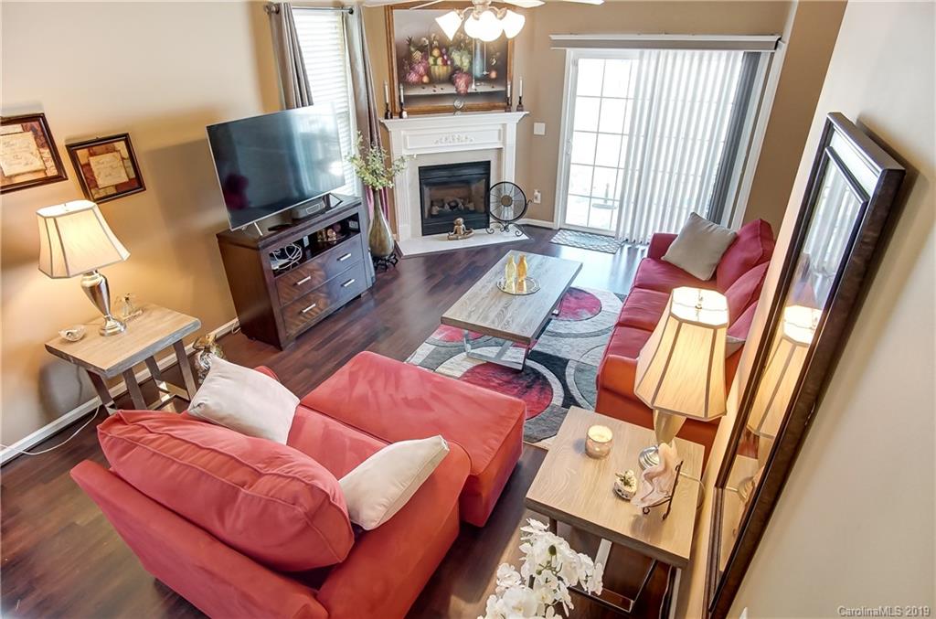 818 Gentlewinds Court Fort Mill, SC 29708 - Photo 4 of 22 a living room with furniture a flat screen tv and a fireplace