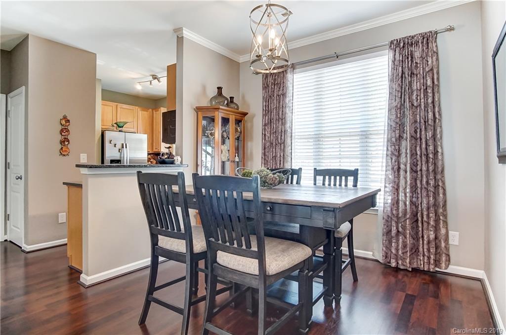 818 Gentlewinds Court Fort Mill, SC 29708 - Photo 6 of 22 a view of a dining room with furniture and wooden floor
