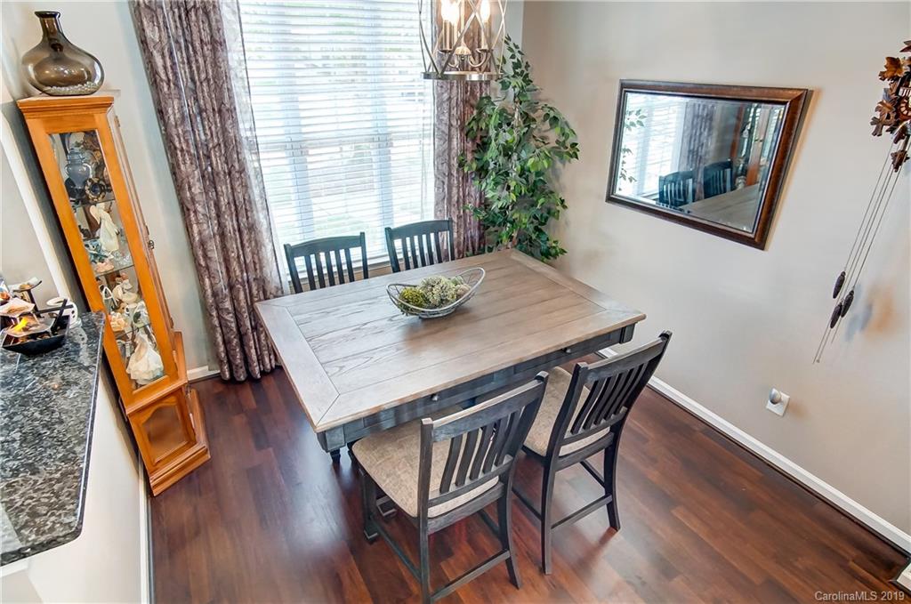 818 Gentlewinds Court Fort Mill, SC 29708 - Photo 7 of 22 a view of a dining room with furniture and wooden floor