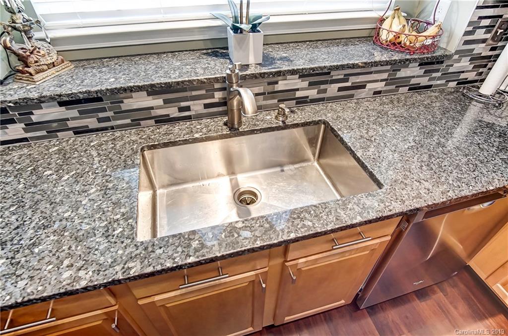 818 Gentlewinds Court Fort Mill, SC 29708 - Photo 10 of 22 a kitchen with granite countertop a sink and a stove