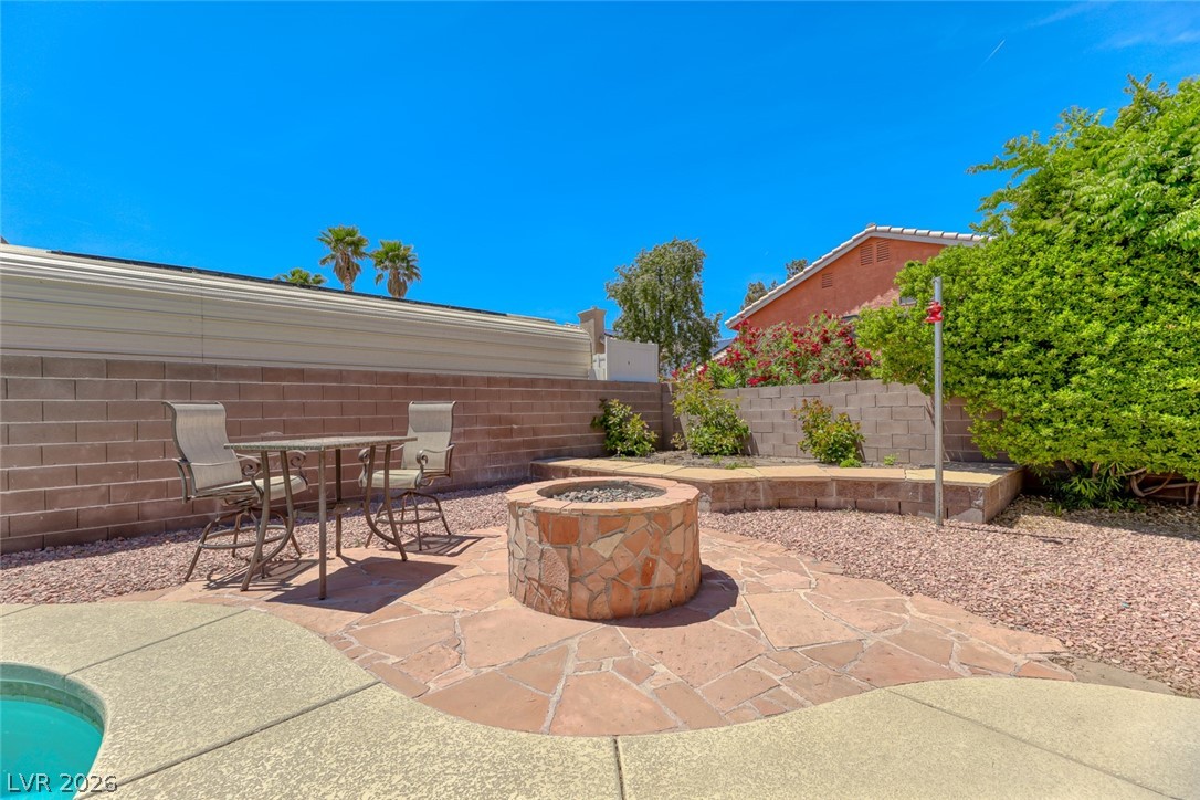 2001 Appaloosa Road Henderson, NV 89002 - Photo 4 of 44 Enjoy outdoor living with a custom stone fire pit and mature landscaping.