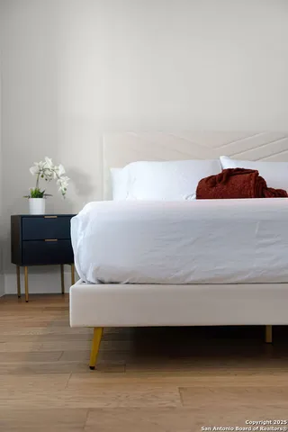 a bathroom with a granite countertop sink a toilet and mirror