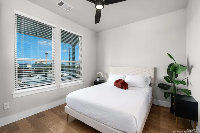a living room with furniture and a potted plant