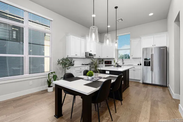 a view of a hallway with wooden floor and stairs