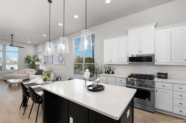 a bathroom with a toilet a sink a vanity and mirror