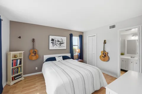 a bedroom with a bed and a painting on the wall