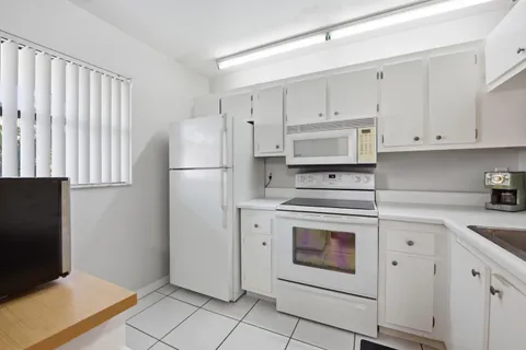 a kitchen with a sink and a stove top oven