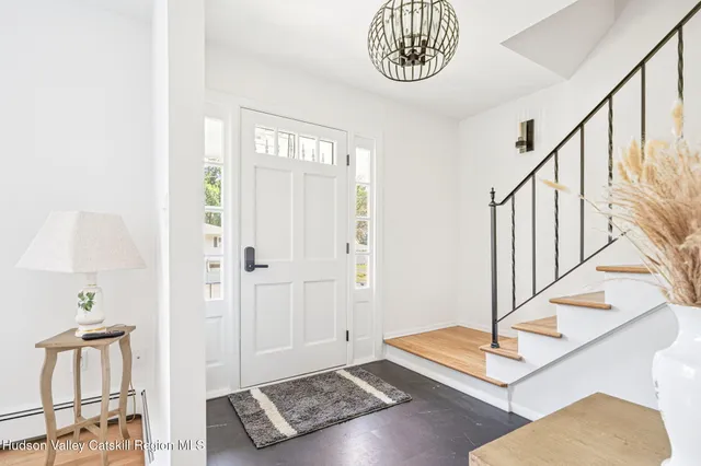 a view of an entryway with wooden floor