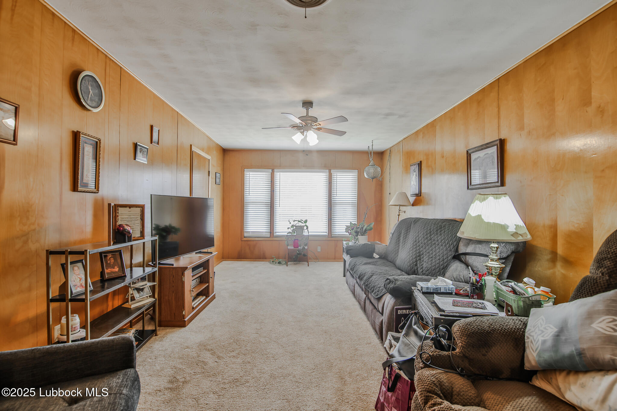 515 East 16th Street Littlefield, TX 79339 - Photo 14 of 32 a living room with furniture a window and a flat screen tv