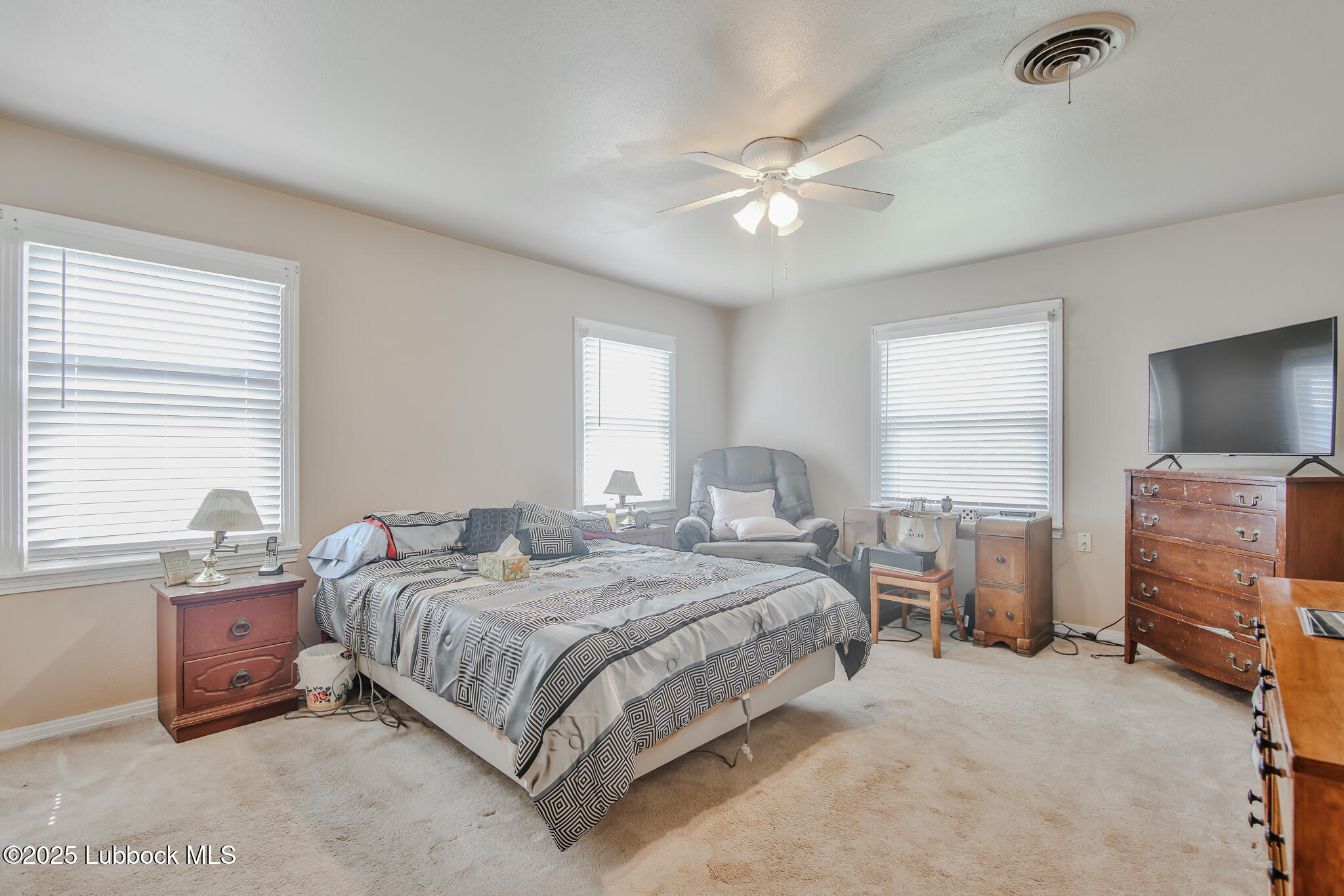 515 East 16th Street Littlefield, TX 79339 - Photo 15 of 32 a bedroom with a bed and a chandelier
