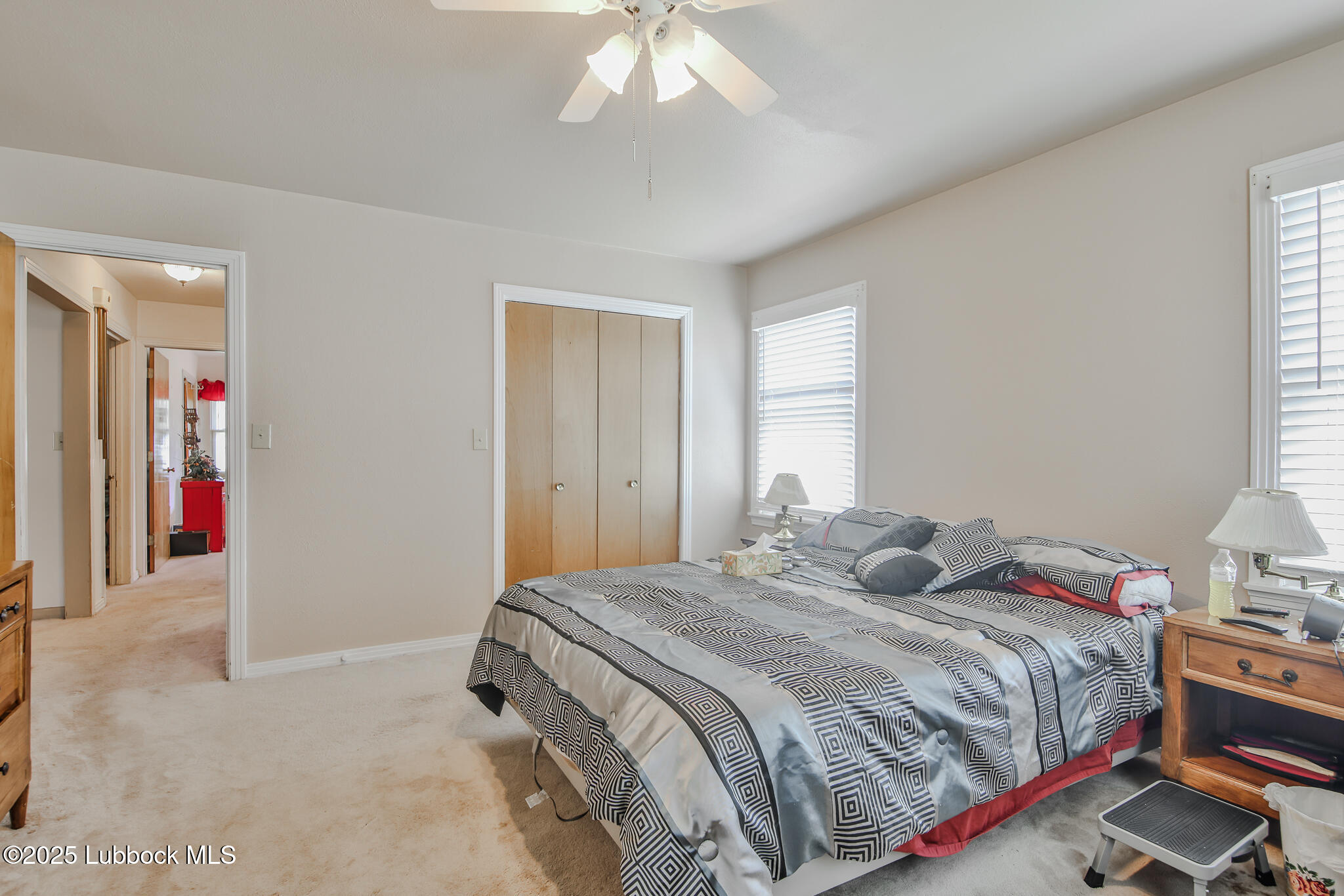 515 East 16th Street Littlefield, TX 79339 - Photo 16 of 32 a bedroom with a bed and a chandelier
