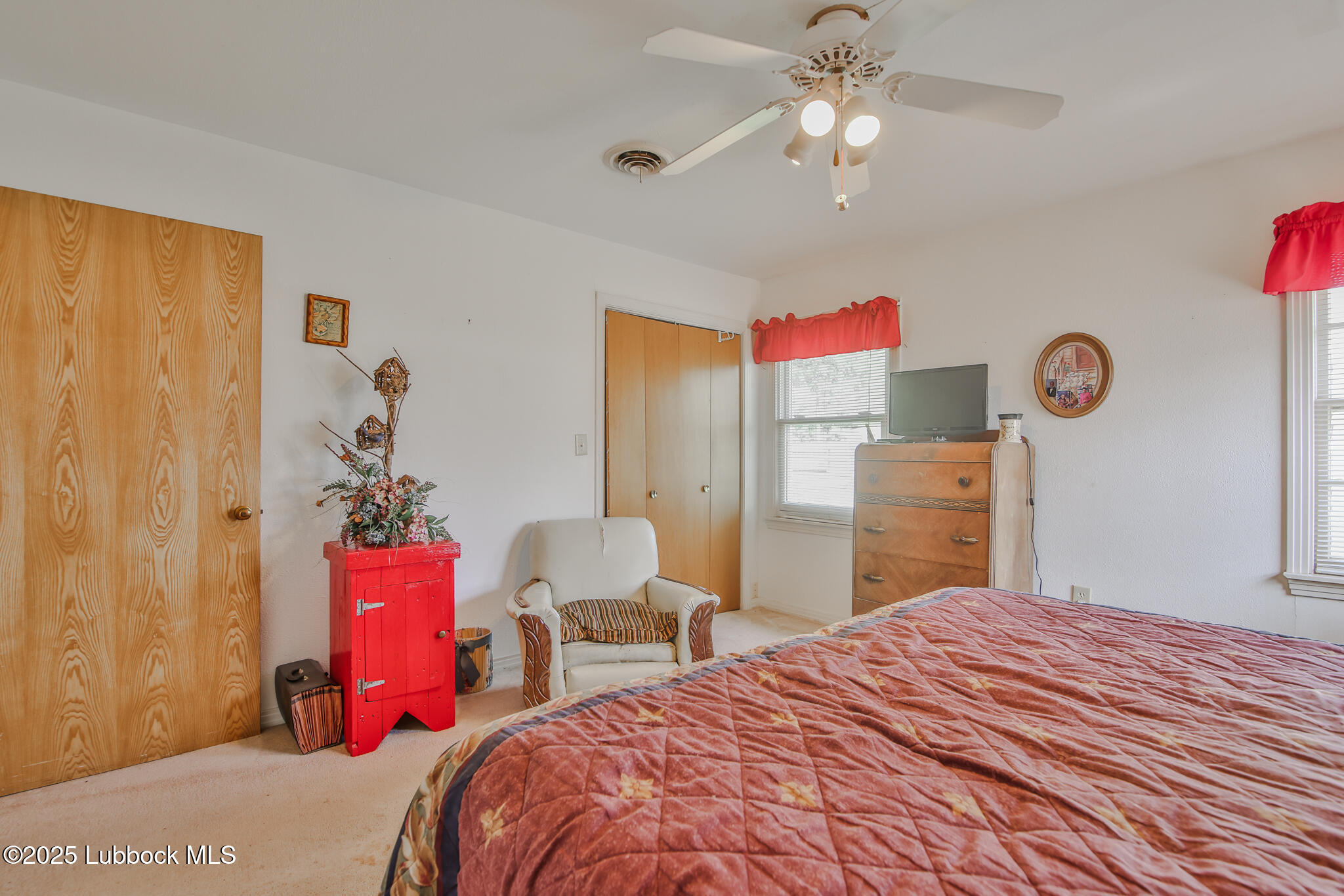 515 East 16th Street Littlefield, TX 79339 - Photo 20 of 32 a bedroom with a bed dresser and a chandelier