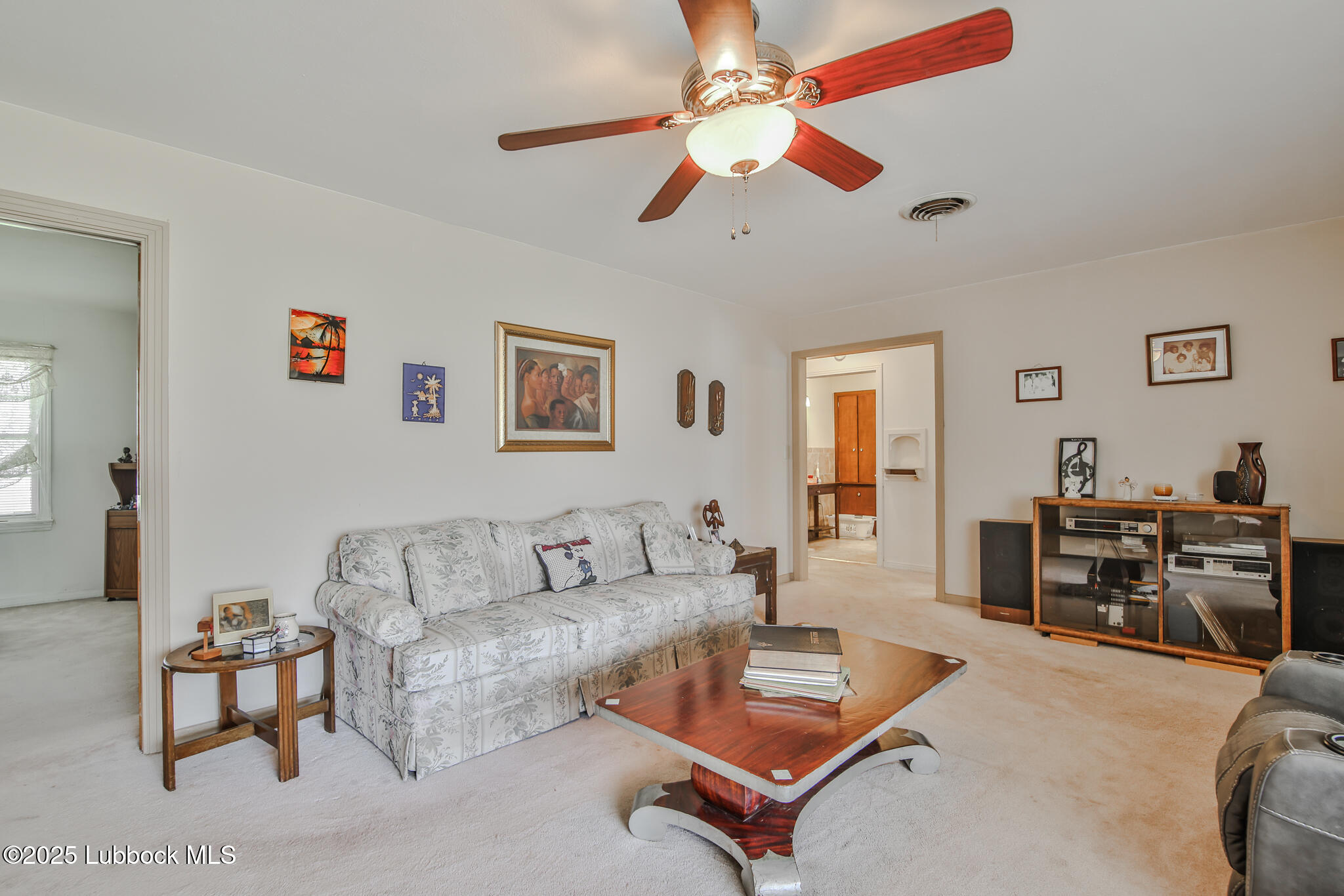 515 East 16th Street Littlefield, TX 79339 - Photo 2 of 32 a living room with furniture and a flat screen tv