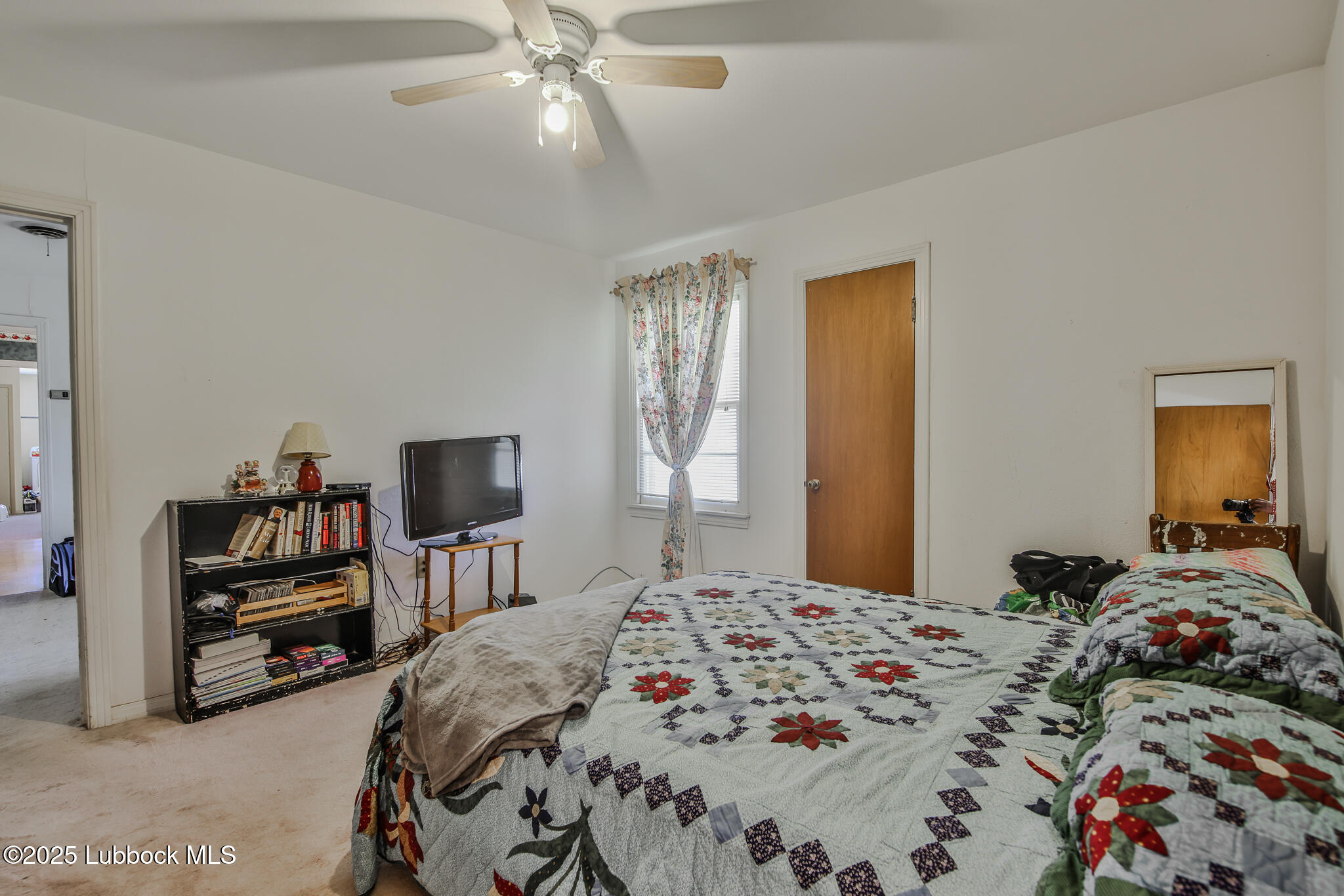 515 East 16th Street Littlefield, TX 79339 - Photo 21 of 32 a bedroom with a bed and a chandelier