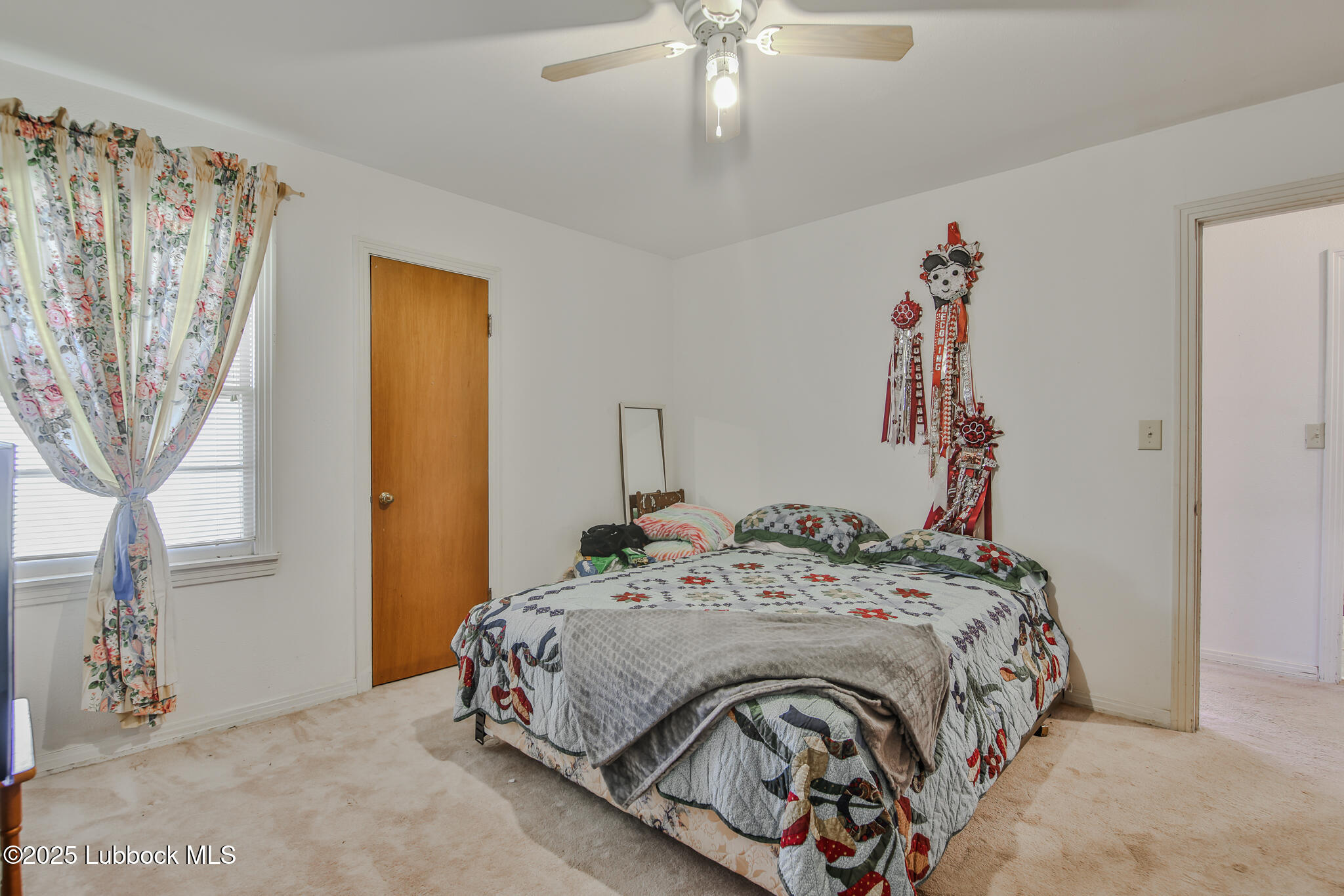 515 East 16th Street Littlefield, TX 79339 - Photo 22 of 32 a bedroom with a bed and a chandelier