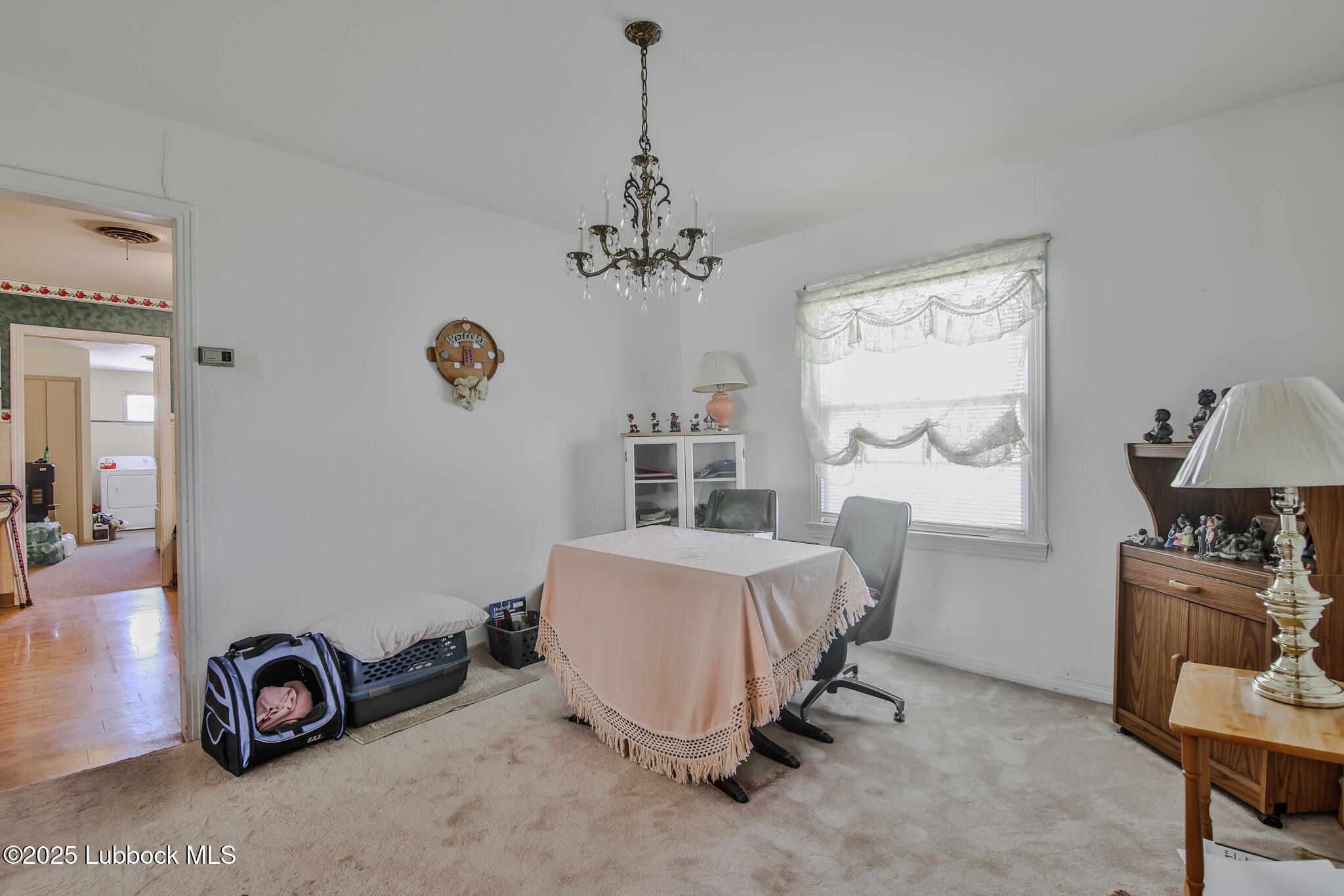 515 East 16th Street Littlefield, TX 79339 - Photo 23 of 32 a room with a bed and a chandelier