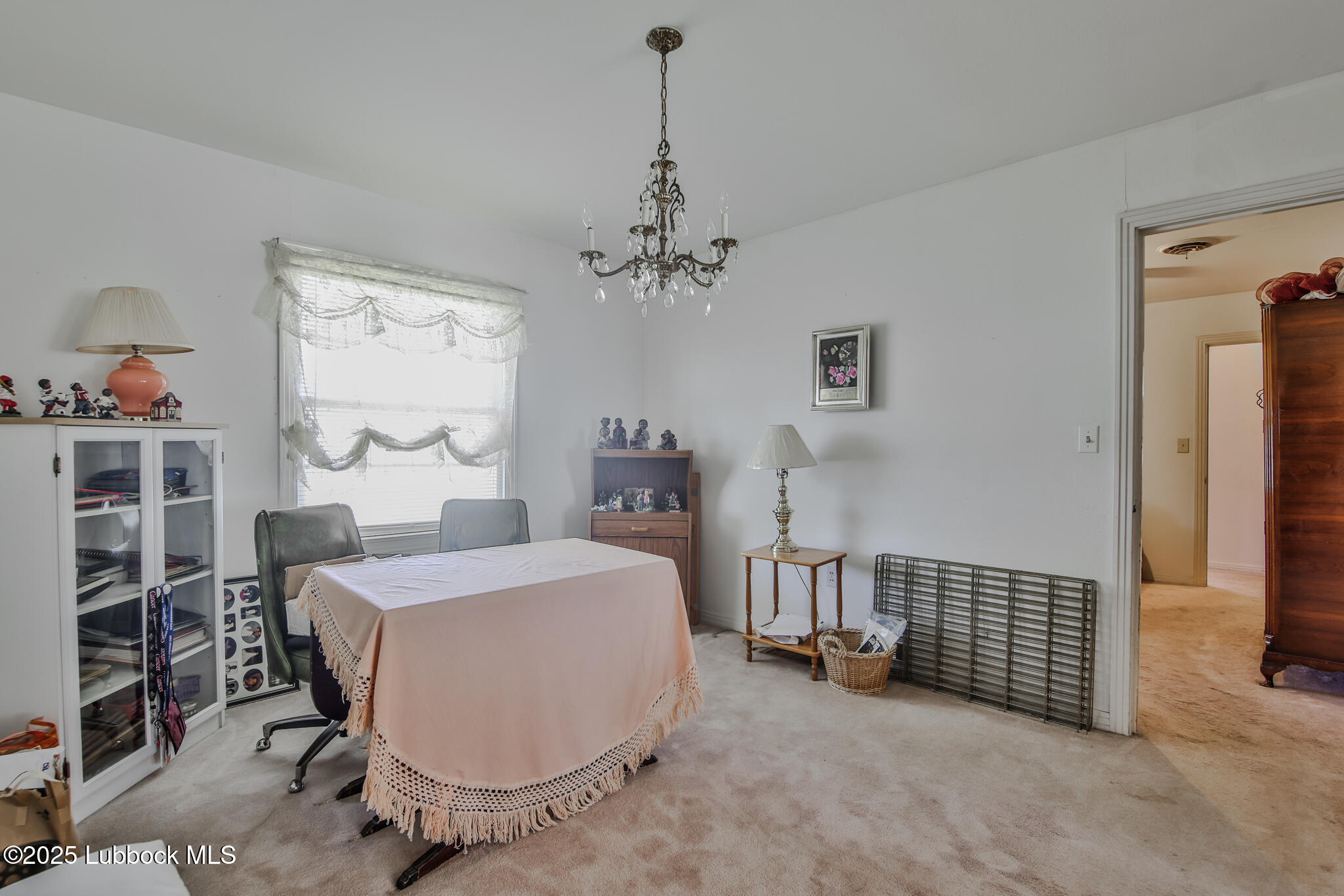 515 East 16th Street Littlefield, TX 79339 - Photo 24 of 32 a bed room with a bed and a chandelier