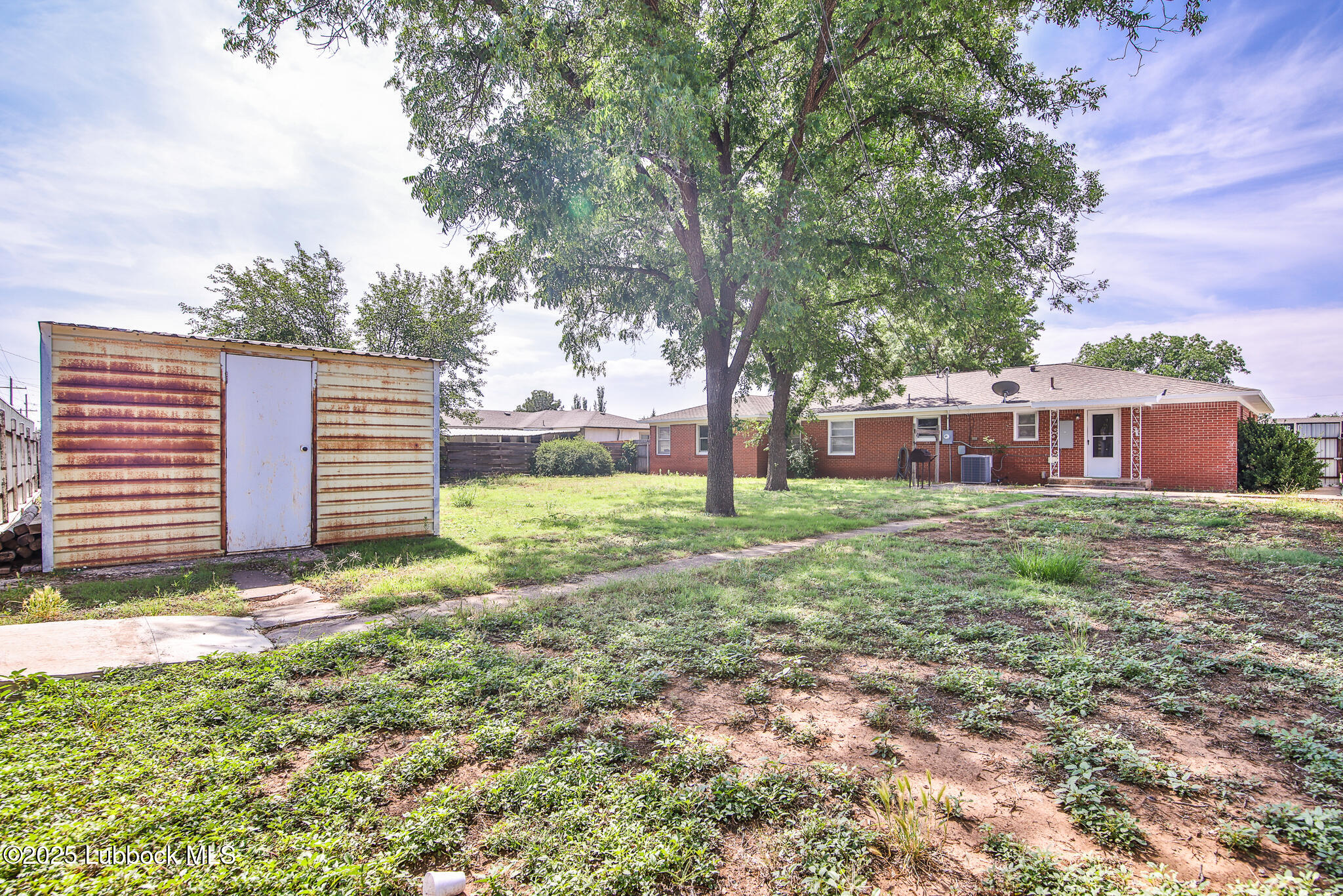 515 East 16th Street Littlefield, TX 79339 - Photo 28 of 32 a view of a house with yard and a tree