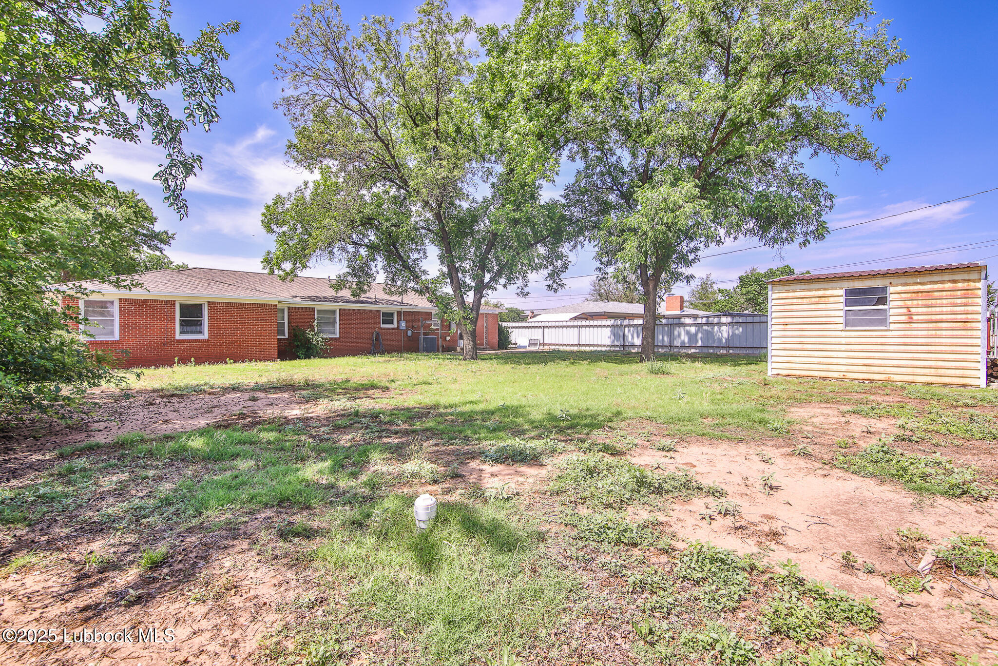 515 East 16th Street Littlefield, TX 79339 - Photo 30 of 32 a view of a house with backyard and tree