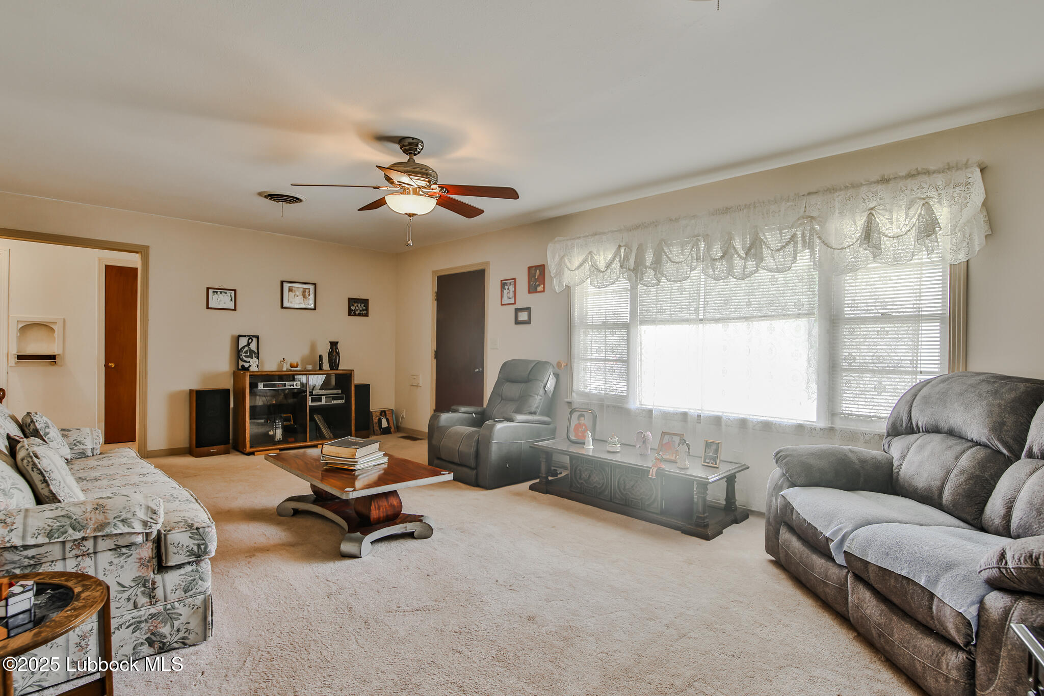 515 East 16th Street Littlefield, TX 79339 - Photo 3 of 32 a living room with furniture and a large window