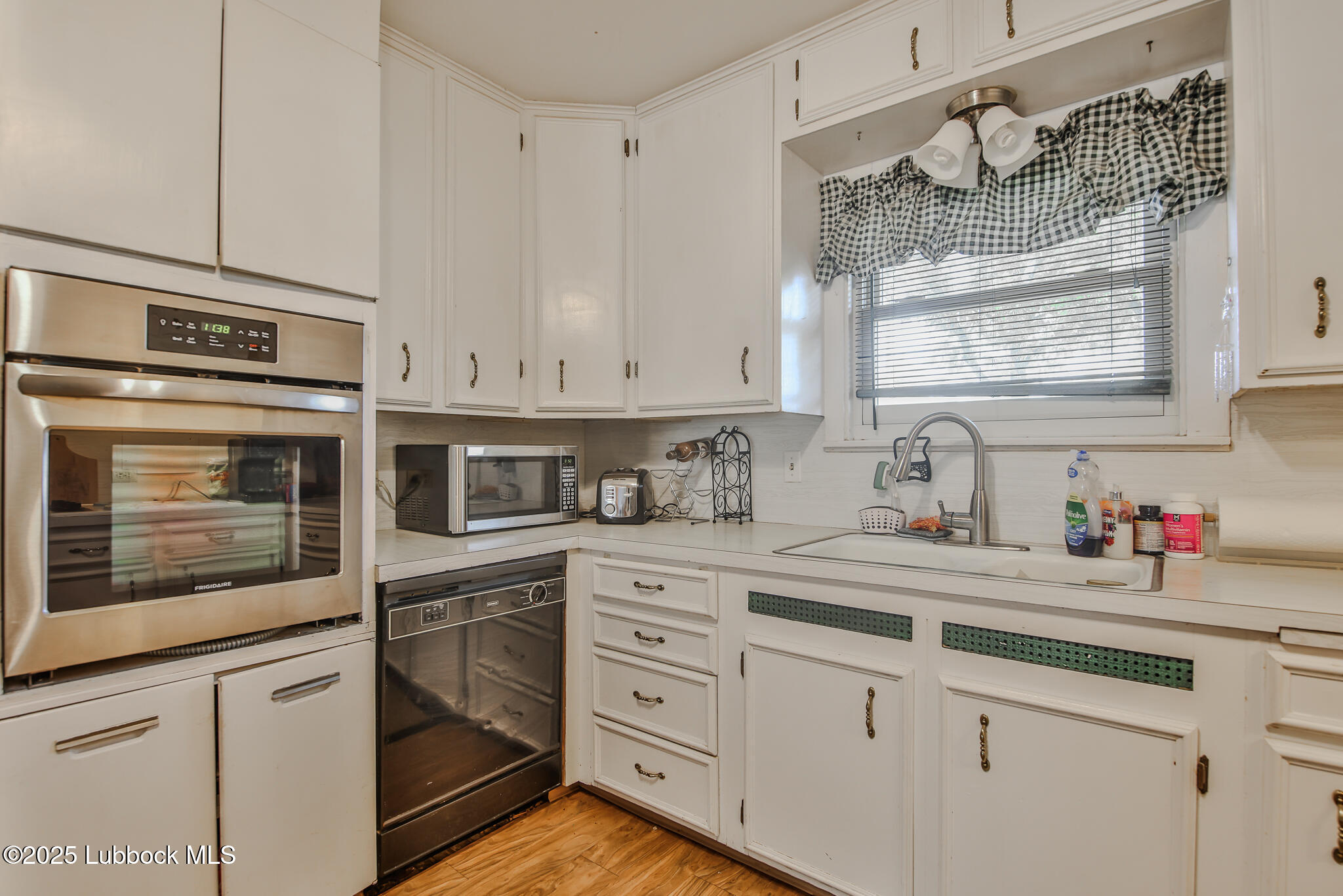 515 East 16th Street Littlefield, TX 79339 - Photo 9 of 32 a kitchen with cabinets stainless steel appliances a sink and cabinets