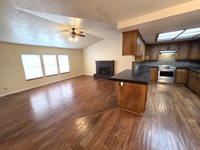 a view of kitchen with cabinets and wooden floor