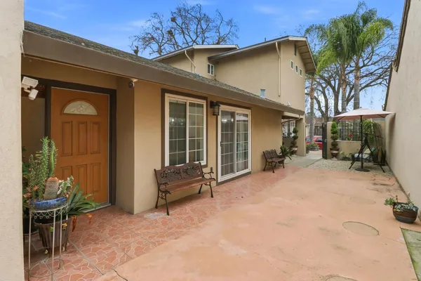 a view of a house with backyard and sitting area