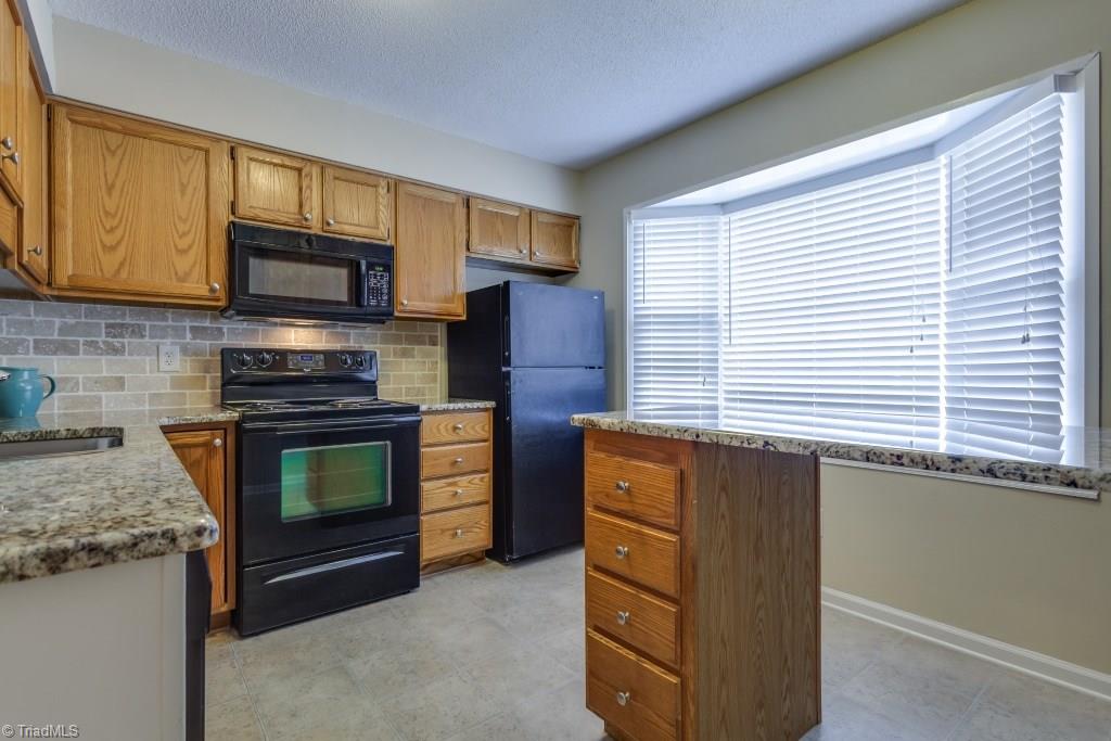 4843 Tower Road, Unit B Greensboro, NC 27410 - Photo 3 of 22 Kitchen w/new granite countertops, and an island/peninsula perfect for Breakfast area.