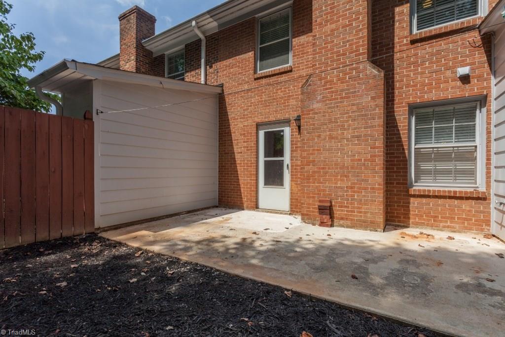 4843 Tower Road, Unit B Greensboro, NC 27410 - Photo 21 of 22 Exterior Back - fully fenced w/privacy fence.
