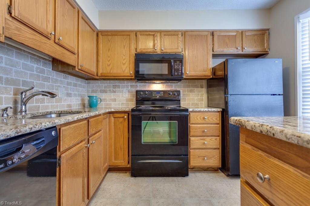 4843 Tower Road, Unit B Greensboro, NC 27410 - Photo 4 of 22 Kitchen also includes new tile backsplash & newer fixtures.