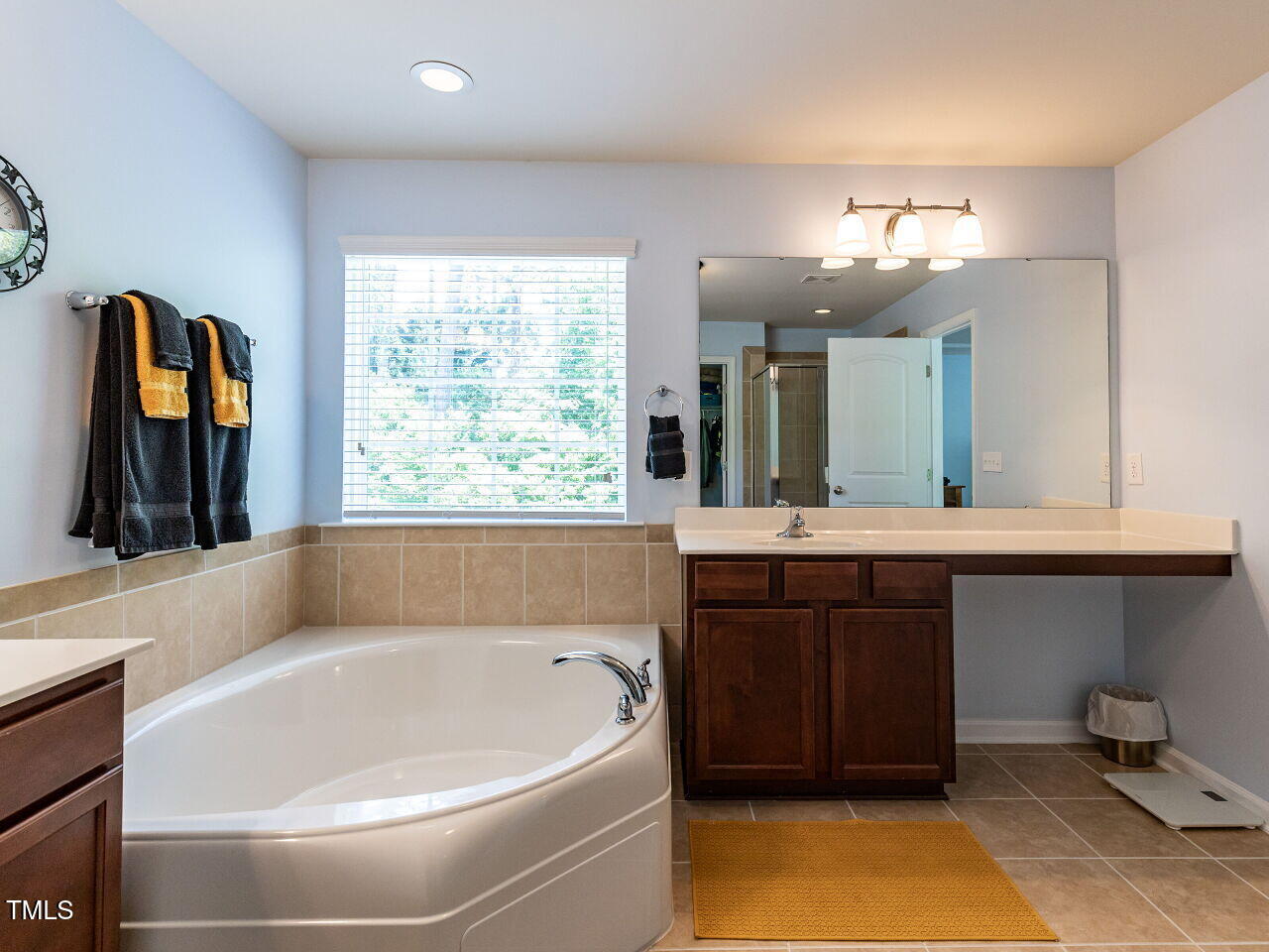 112 Victorian Oaks Drive Durham, NC 27713 - Photo 18 of 32 a bathroom with a tub a sink and a window