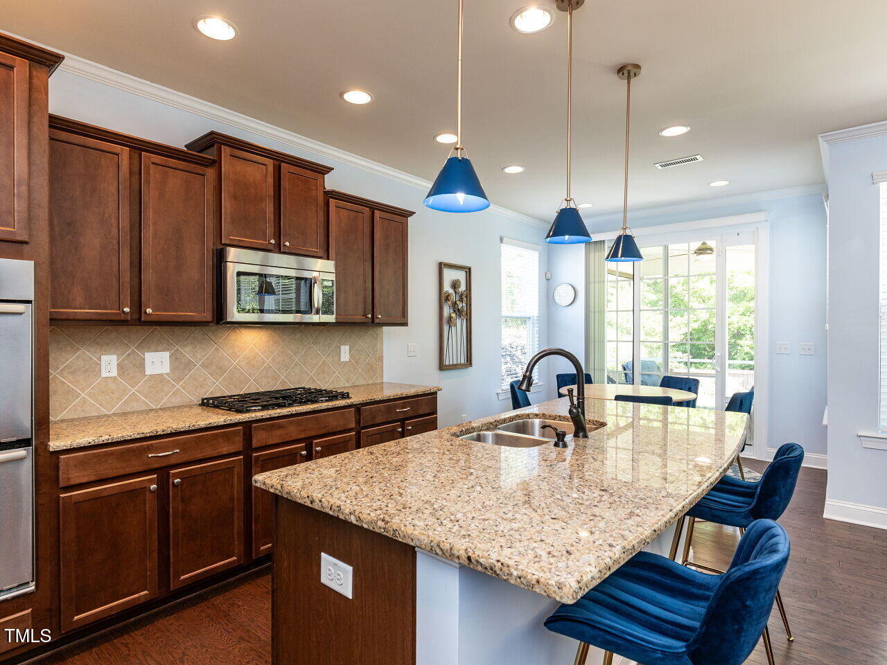 112 Victorian Oaks Drive Durham, NC 27713 - Photo 9 of 32 a kitchen with stainless steel appliances granite countertop a sink a stove and a wooden cabinets